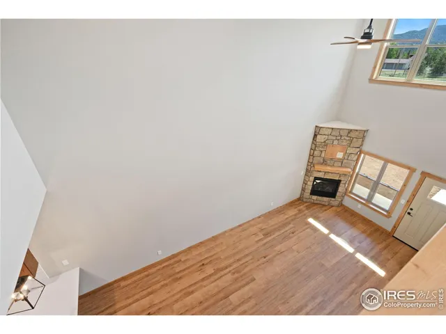 a view of an empty room and wooden floor