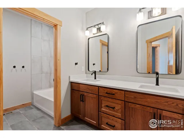 a bathroom with a sink double vanity and a mirror