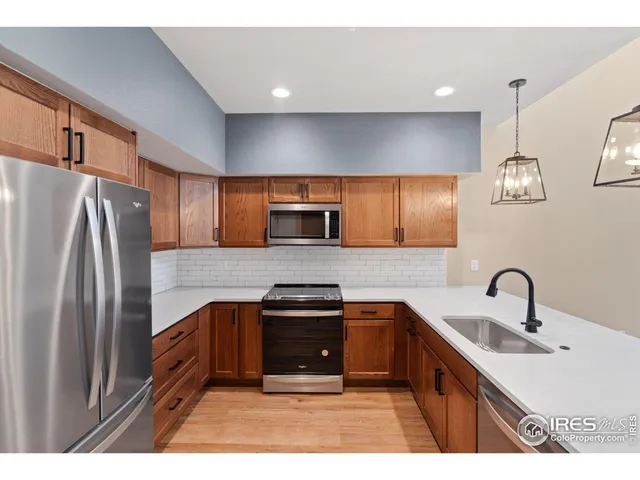 a kitchen with stainless steel appliances a sink stove and refrigerator