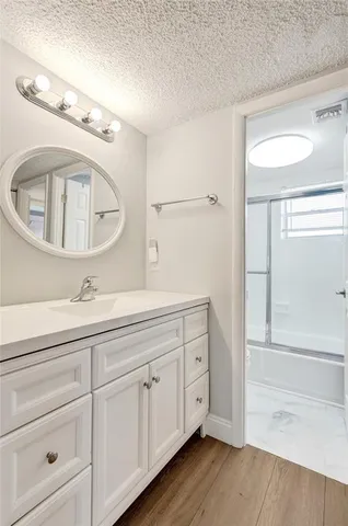 a bathroom with a toilet sink vanity and mirror