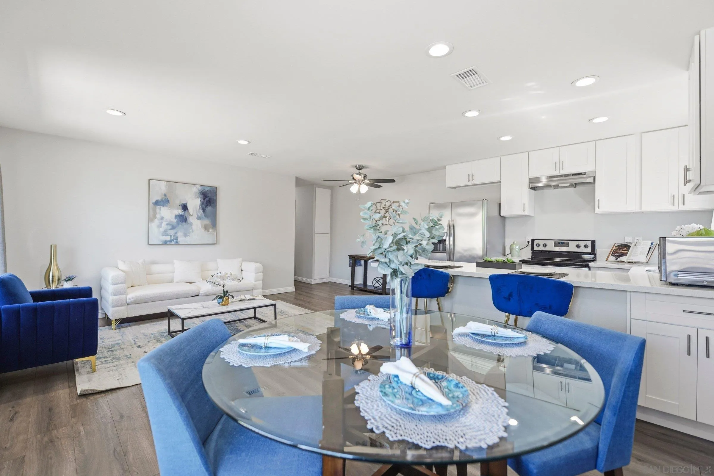 13884 Via Rimini San Diego, CA 92129 - Photo 11 of 24 a dining room with furniture kitchen view and a wooden floor