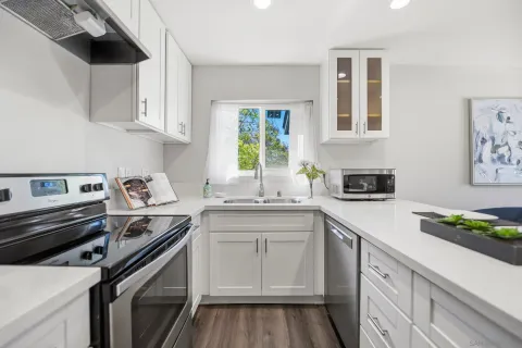 a kitchen with a sink stove and cabinets