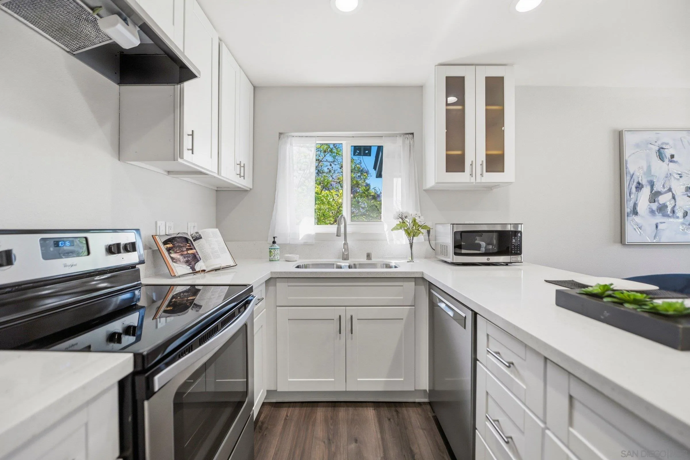 13884 Via Rimini San Diego, CA 92129 - Photo 14 of 24 a kitchen with a sink stove and cabinets