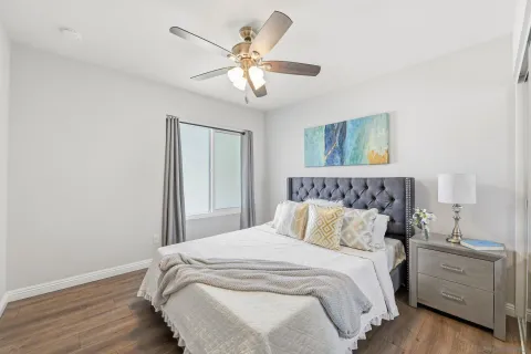 a bedroom with a bed and a chandelier