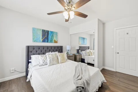 a bedroom with bed and a chandelier