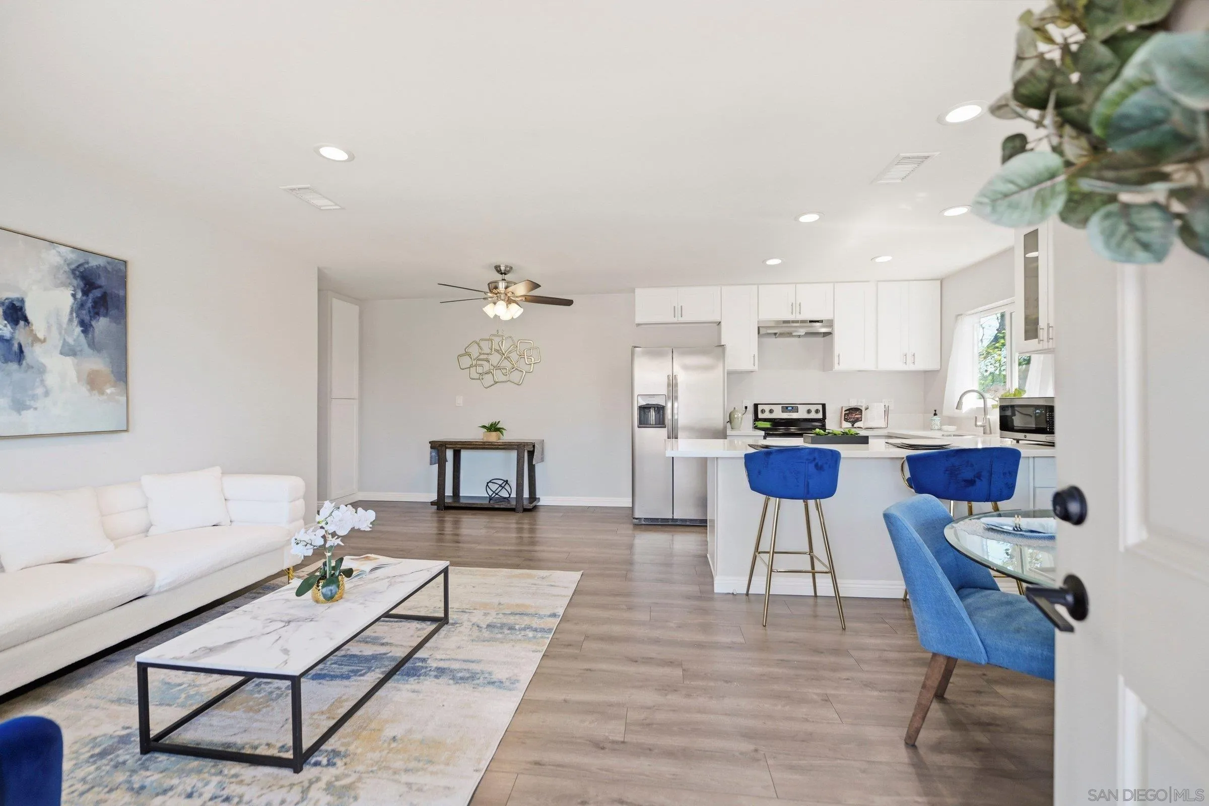 13884 Via Rimini San Diego, CA 92129 - Photo 5 of 24 a living room with furniture and a dining table with kitchen view