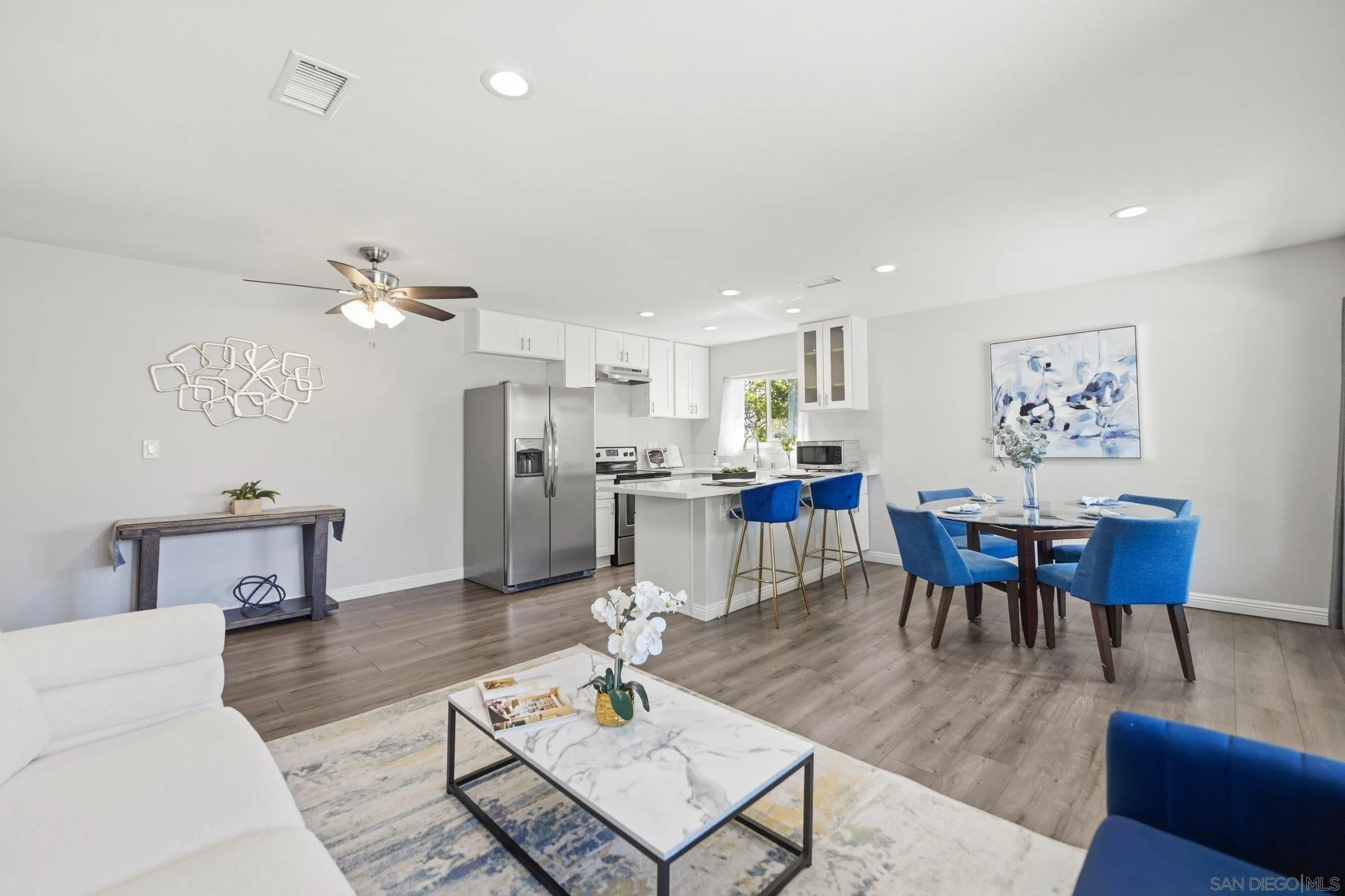 13884 Via Rimini San Diego, CA 92129 - Photo 6 of 24 a living room with furniture kitchen view and a dining table