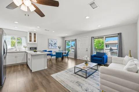 a living room with furniture and wooden floor