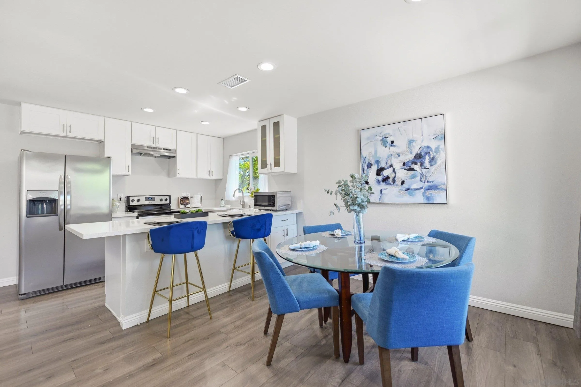 13884 Via Rimini San Diego, CA 92129 - Photo 10 of 24 a view of a dining room with furniture wooden floor and a kitchen