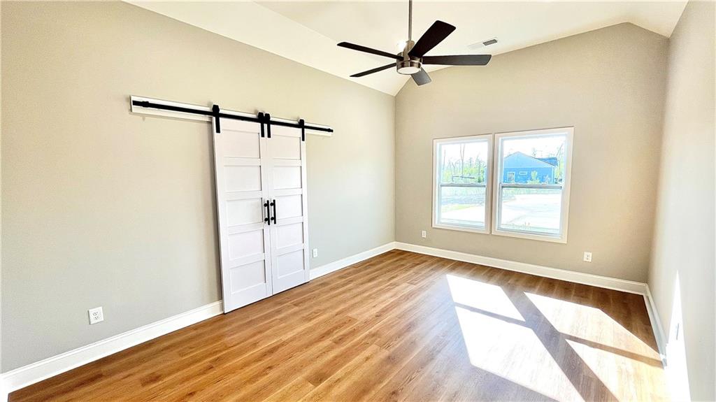 23 S Road Griffin, GA 30224 - Photo 14 of 32 a view of an empty room with wooden floor and a window