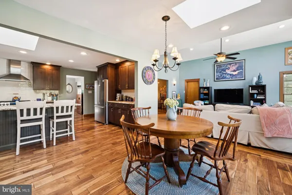 a large kitchen with a table and chairs