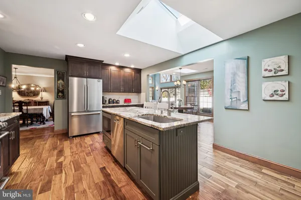a kitchen with kitchen island a sink stove and refrigerator