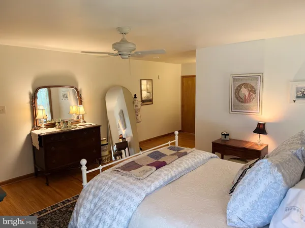 a bedroom with a bed and a mirror