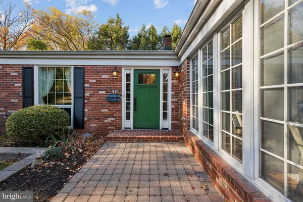 a view of a brick house with large windows