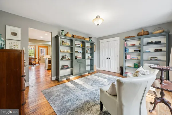 a living room with furniture cabinets and a flat screen tv