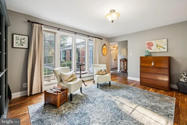 a living room with furniture stairs and a window