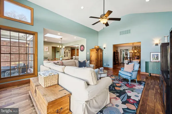 a living room with furniture fireplace and a large window