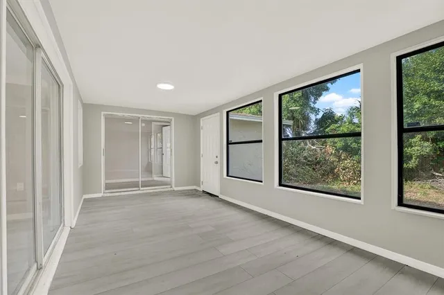 an empty room with windows and closet