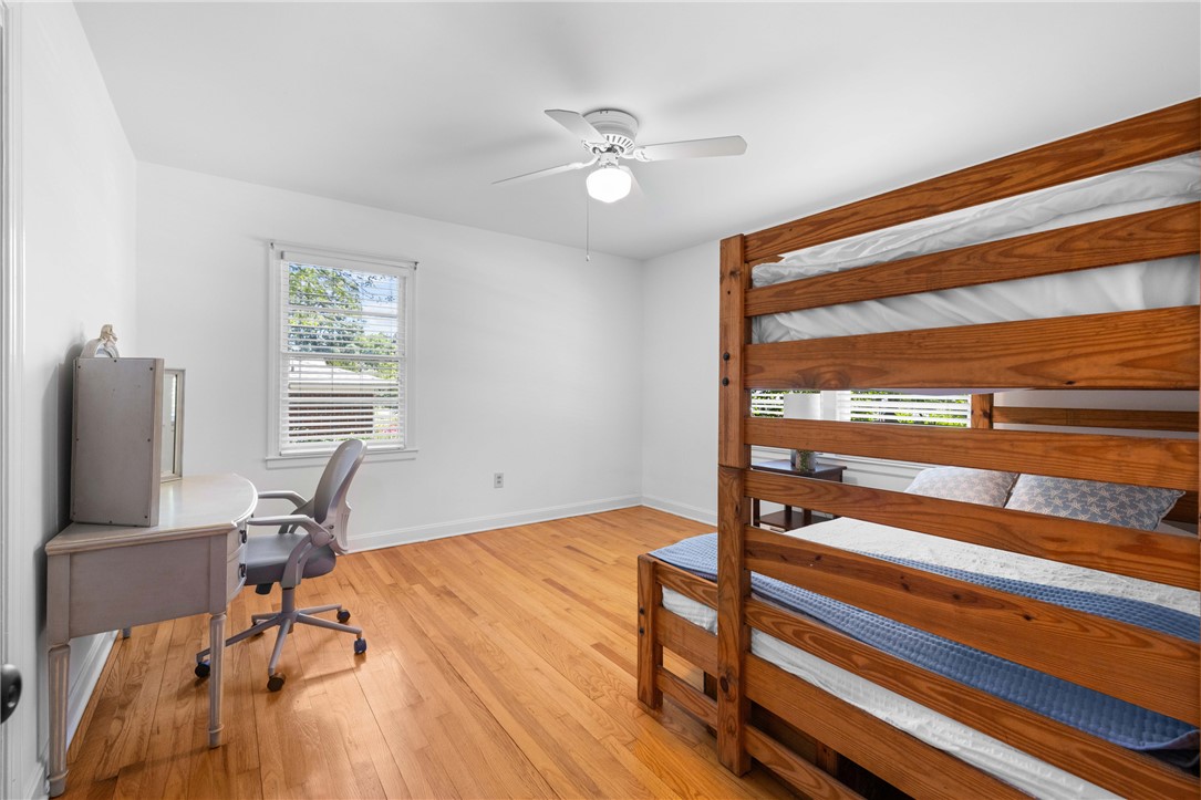 207 Brook Street Clemson, SC 29631 - Photo 20 of 39 Hardwood floors and a ceiling fan complete this cozy bedroom, perfect for rest or study.