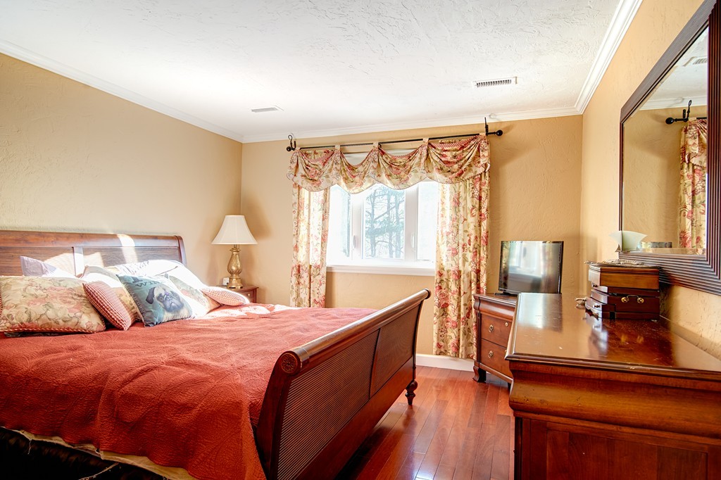 35 Cobblestone Lane, Unit 35 Worcester, MA 01606 - Photo 11 of 21 a bedroom with a bed and wooden floor