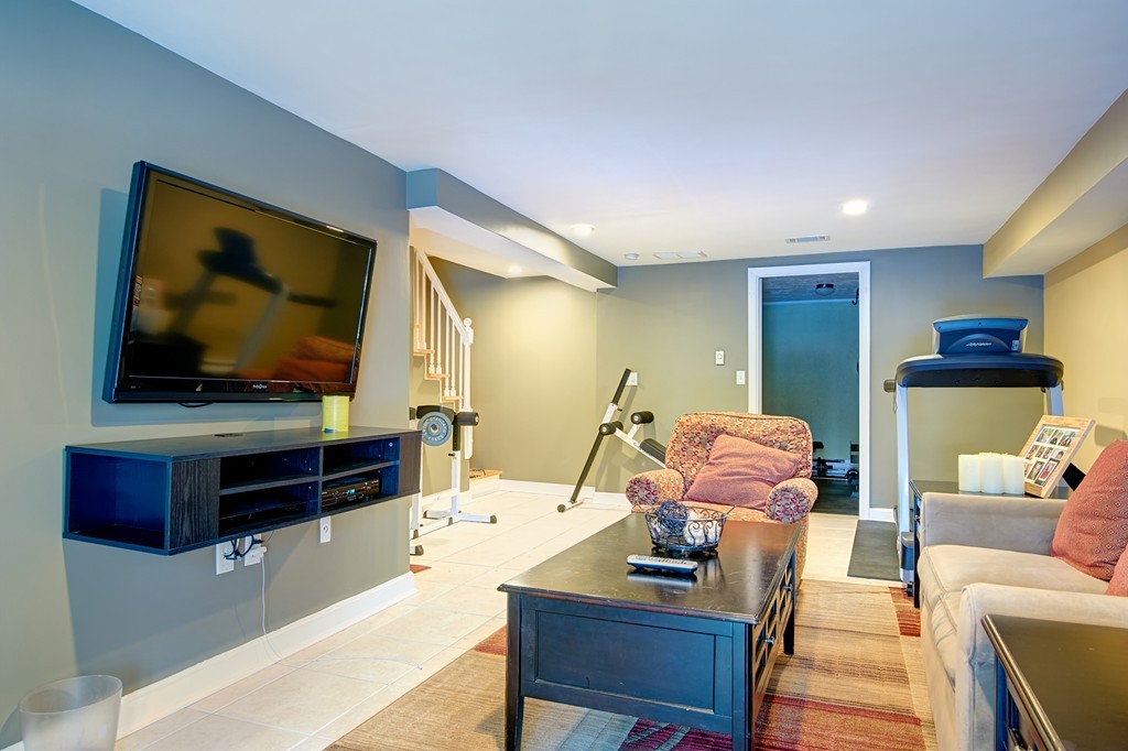 35 Cobblestone Lane, Unit 35 Worcester, MA 01606 - Photo 18 of 21 a living room with furniture and a flat screen tv