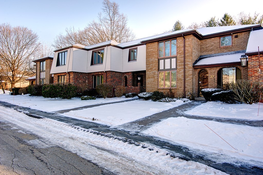 35 Cobblestone Lane, Unit 35 Worcester, MA 01606 - Photo 2 of 21 a front view of a house with a yard and a garage