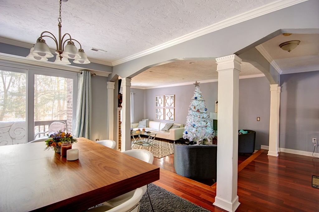 35 Cobblestone Lane, Unit 35 Worcester, MA 01606 - Photo 8 of 21 a view of a dining room and livingroom with furniture wooden floor a chandelier