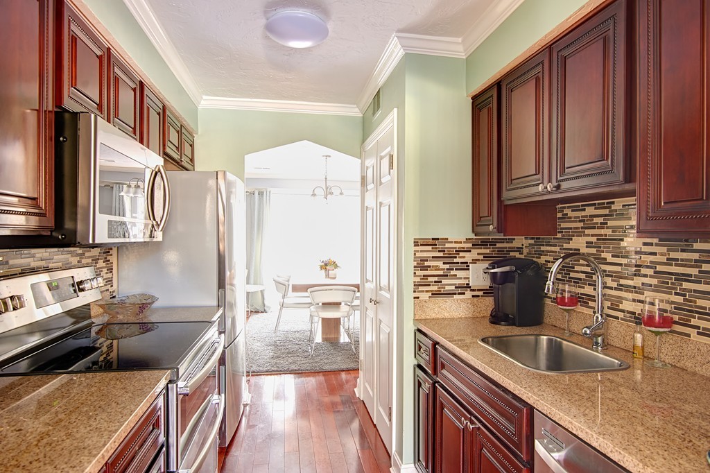 35 Cobblestone Lane, Unit 35 Worcester, MA 01606 - Photo 10 of 21 a kitchen with stainless steel appliances granite countertop a sink stove and refrigerator
