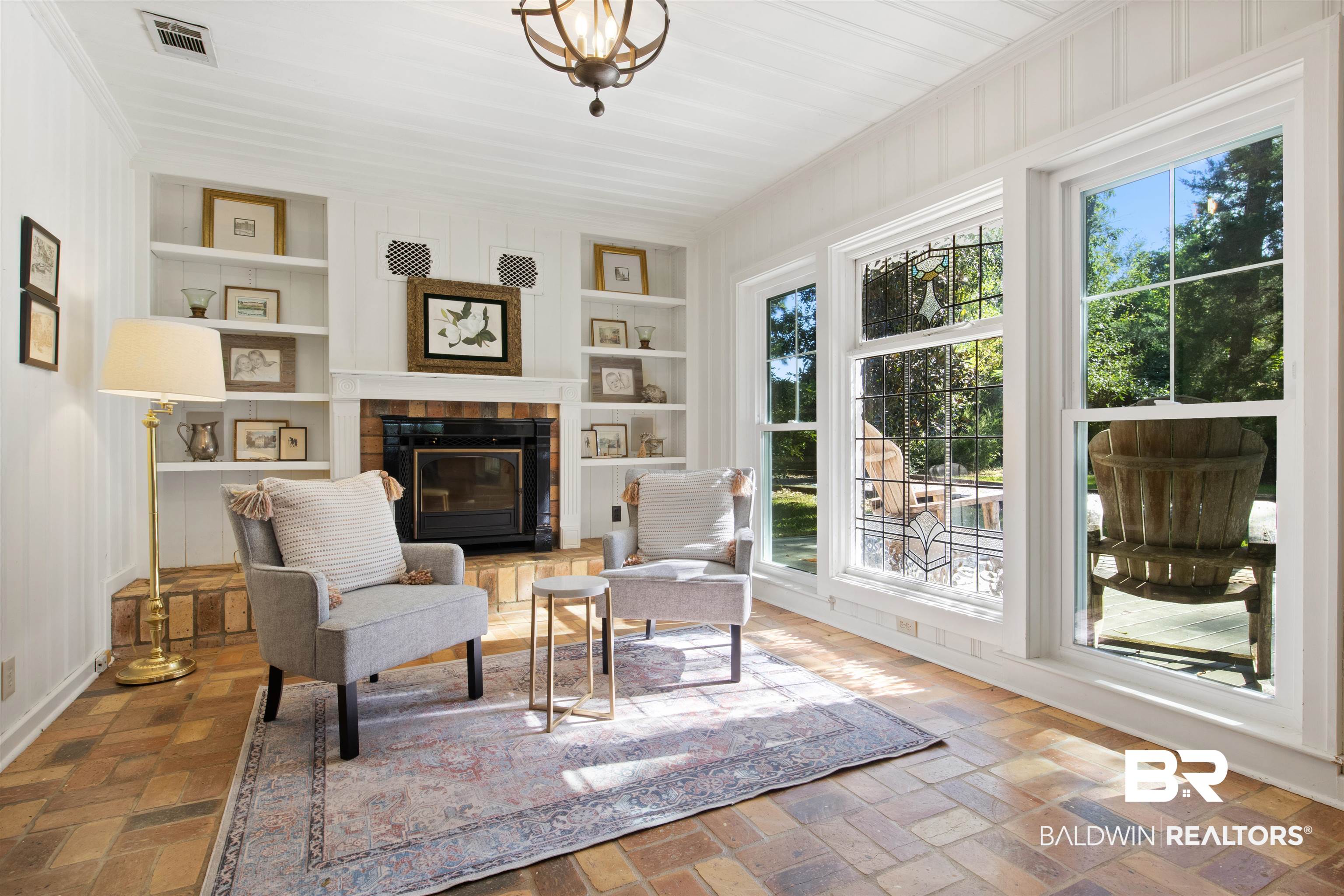 15100 Vasko Road Silverhill, AL 36576 - Photo 18 of 51 Sitting area featuring a tiled fireplace and built in features and split brick floors.