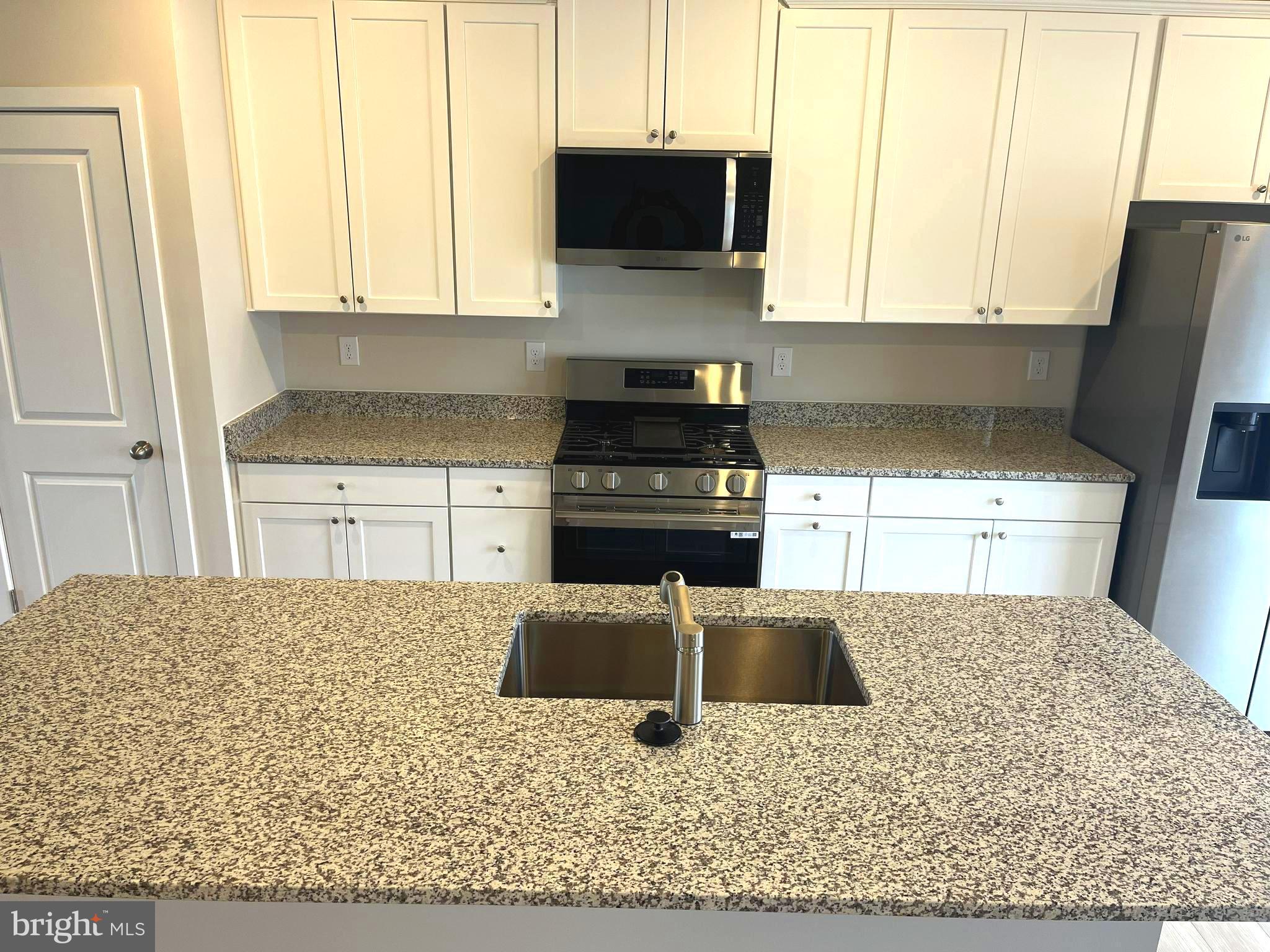 7618 Johnnycake Road Windsor Mill, MD 21244 - Photo 12 of 45 a kitchen with a stove a sink and a microwave