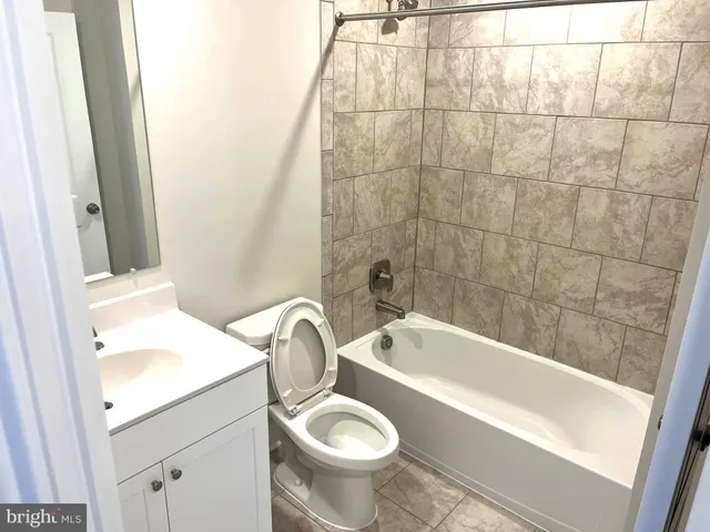 a bathroom with a sink a toilet and bathtub