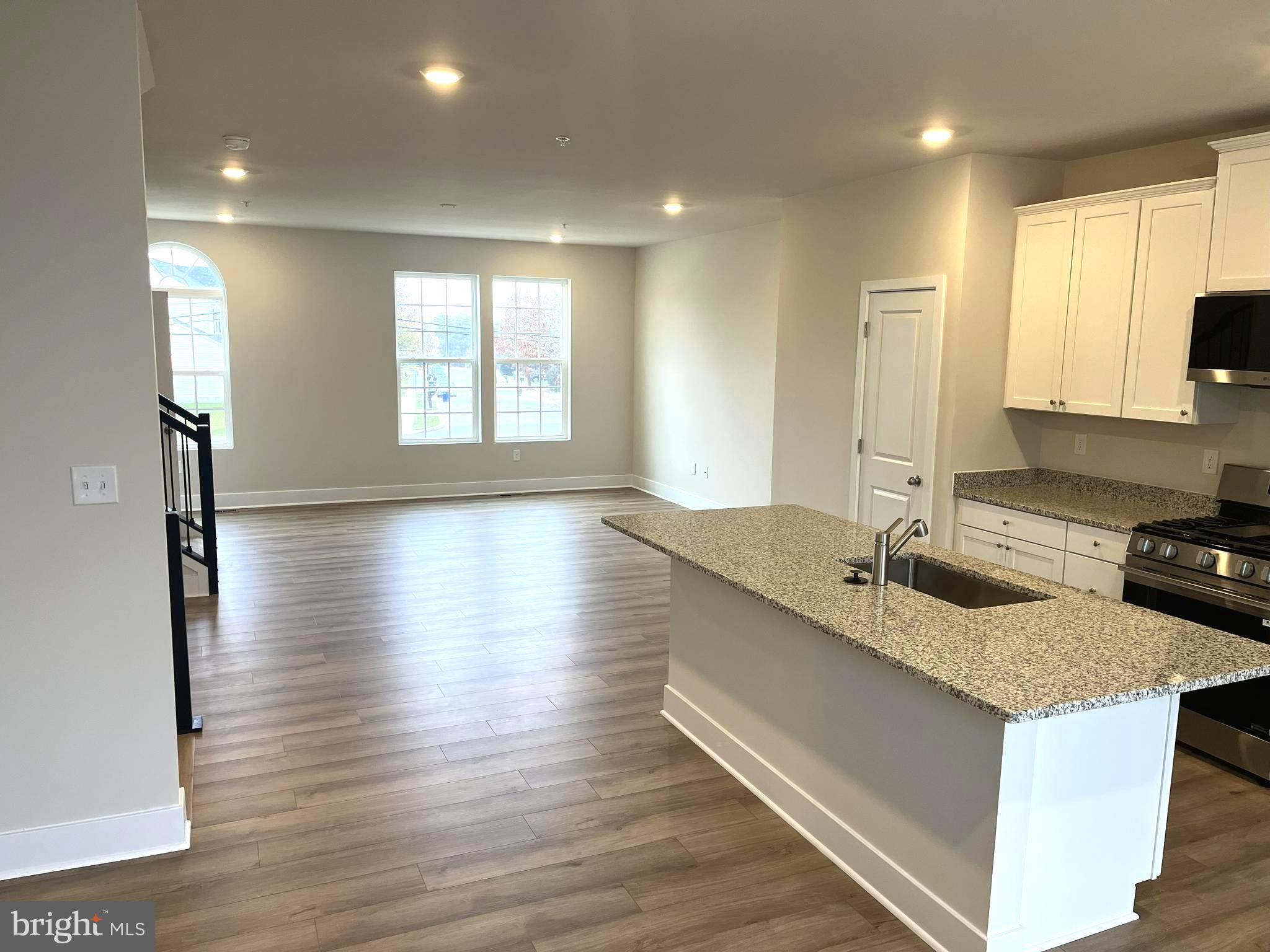 7618 Johnnycake Road Windsor Mill, MD 21244 - Photo 3 of 45 a kitchen with granite countertop a sink and a stove top oven