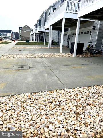 a view of a white apartments with large trees