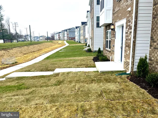 a house view with a seating space and a garden