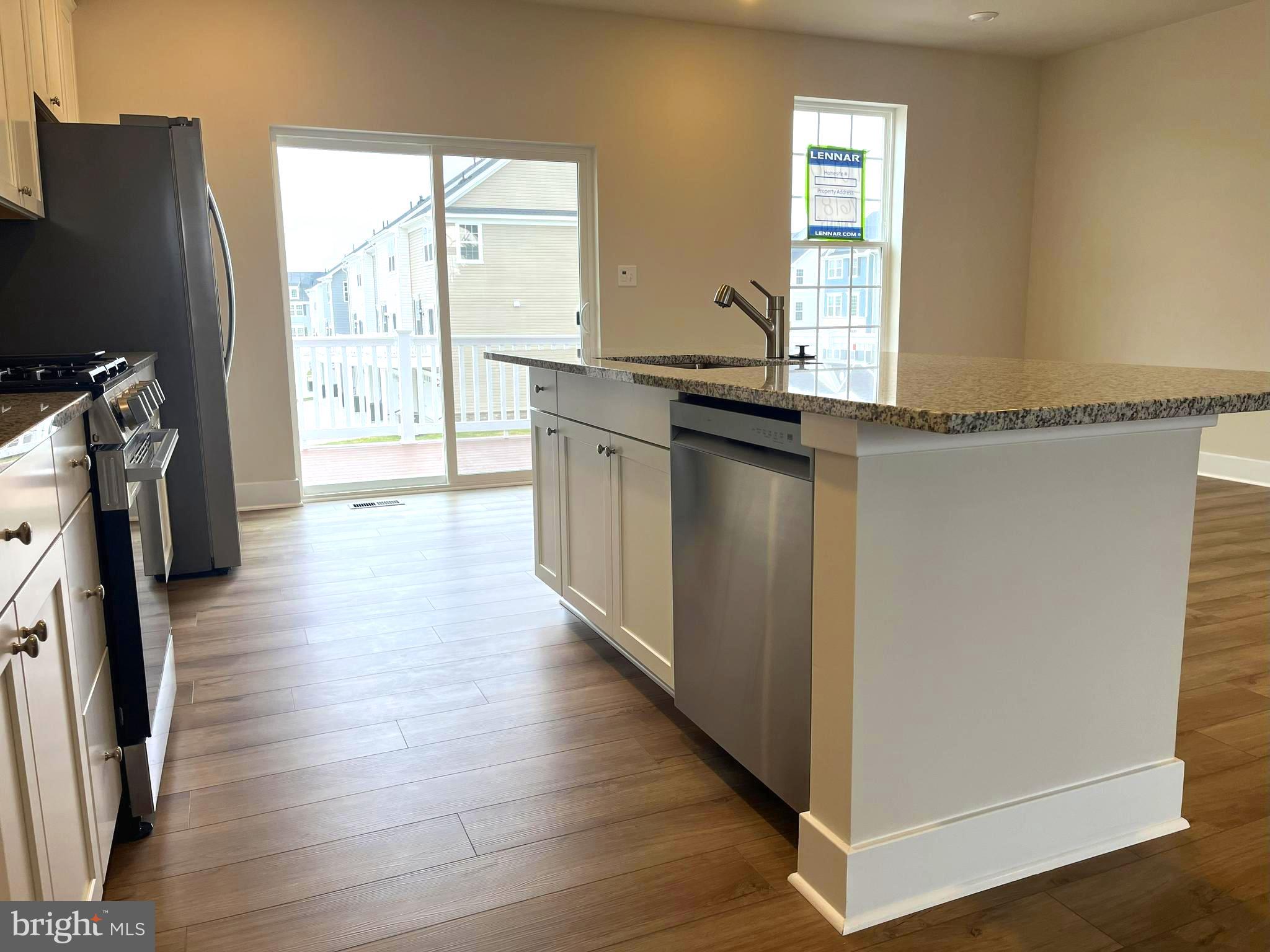 7618 Johnnycake Road Windsor Mill, MD 21244 - Photo 8 of 45 a kitchen with stainless steel appliances granite countertop a refrigerator and a sink