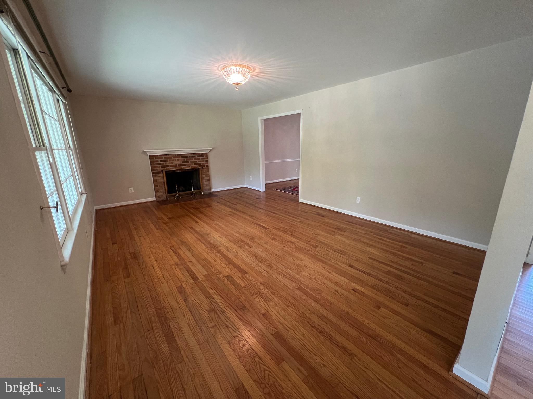 6825 Ridgeway Drive Springfield, VA 22150 - Photo 12 of 33 a view of an empty room with wooden floor and a window