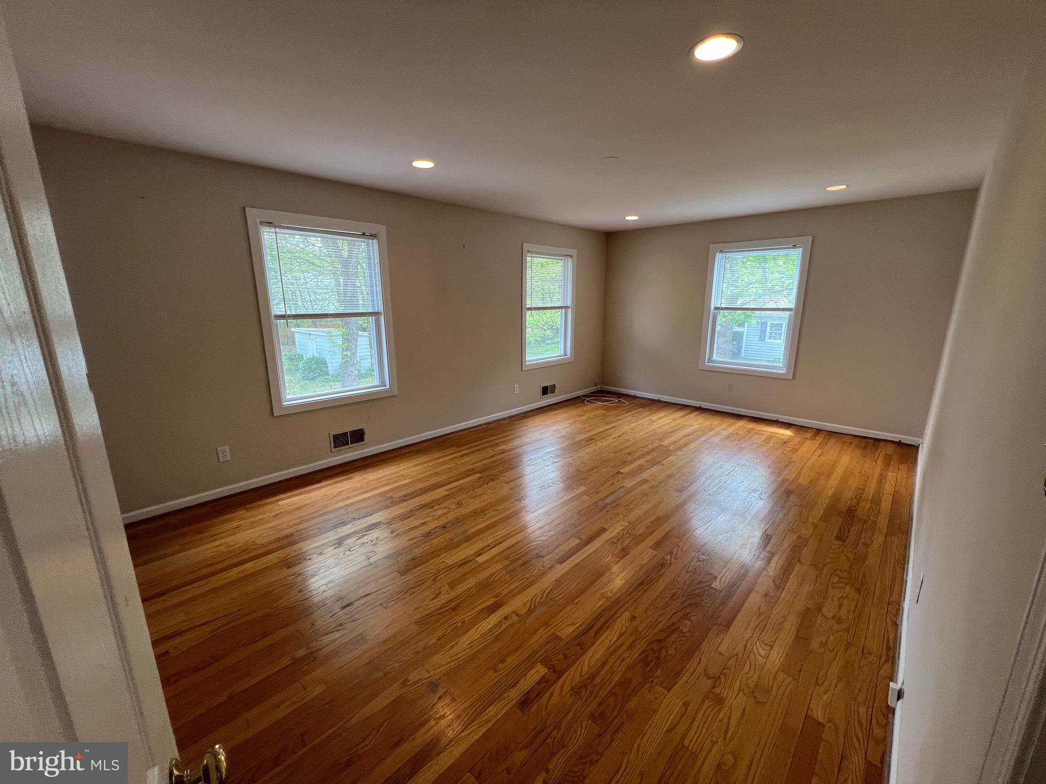 6825 Ridgeway Drive Springfield, VA 22150 - Photo 20 of 33 a view of an empty room with wooden floor and a window