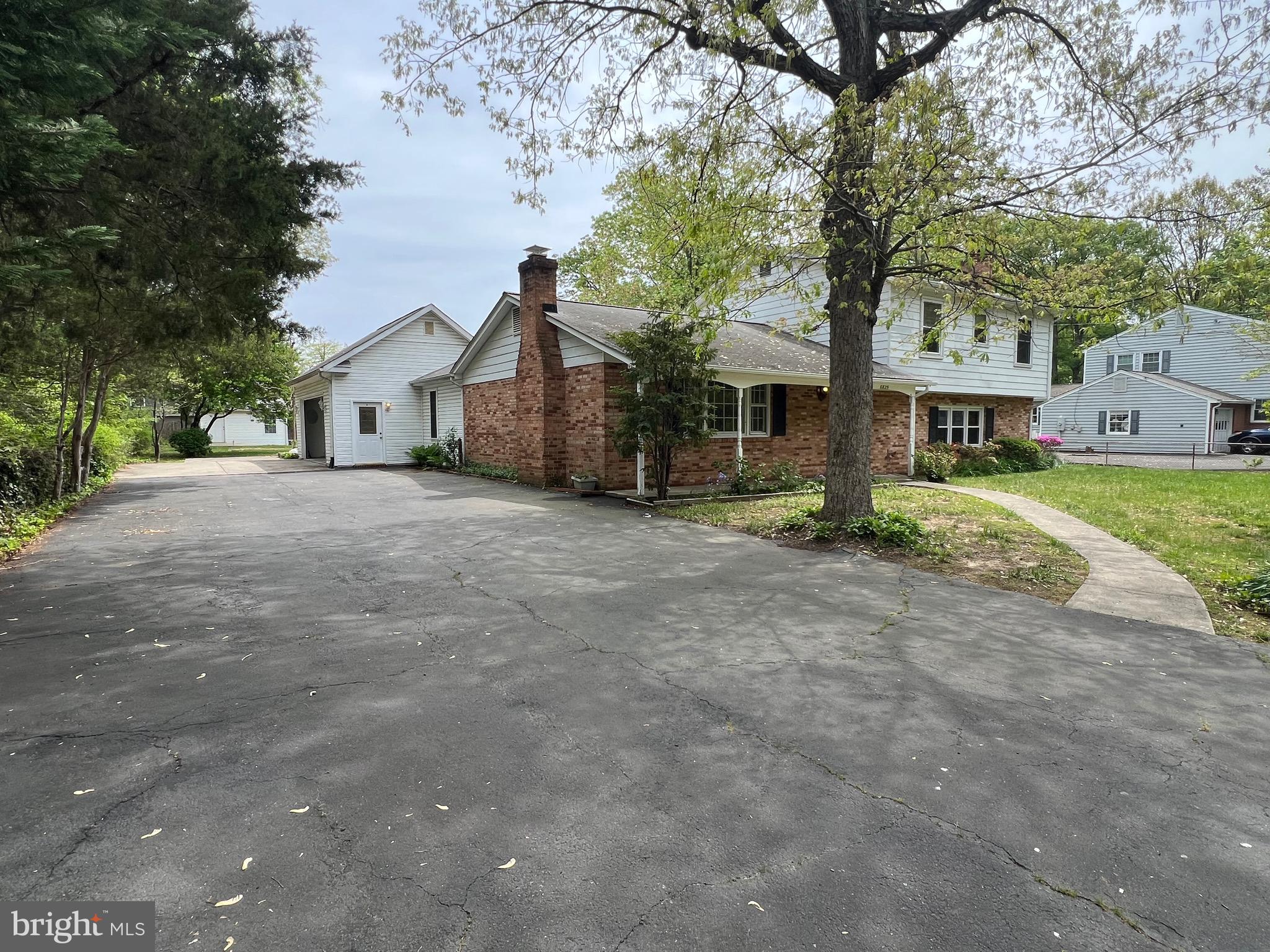 6825 Ridgeway Drive Springfield, VA 22150 - Photo 2 of 33 a view of a road with a house in the background