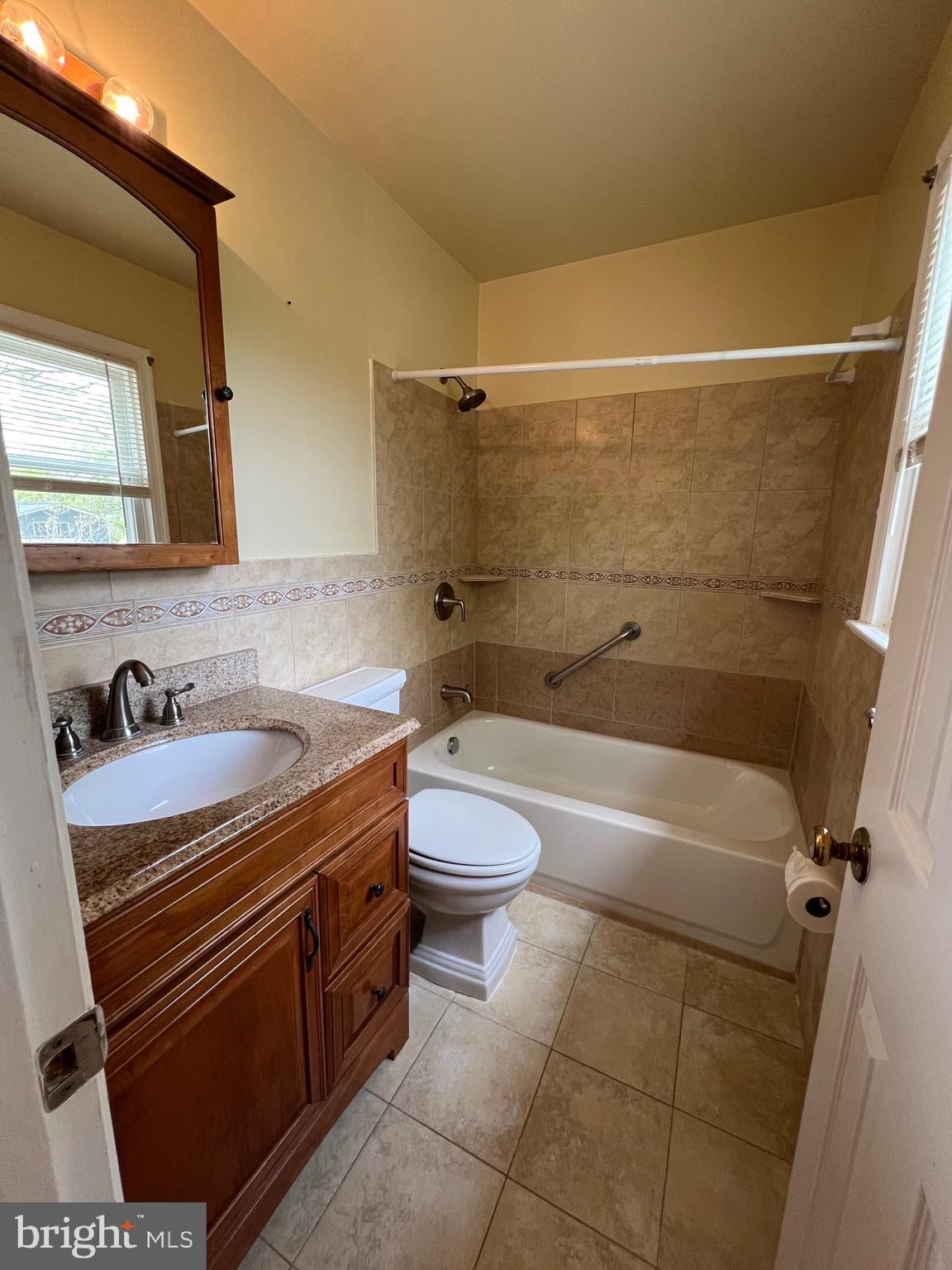 6825 Ridgeway Drive Springfield, VA 22150 - Photo 23 of 33 a bathroom with a granite countertop sink toilet and shower