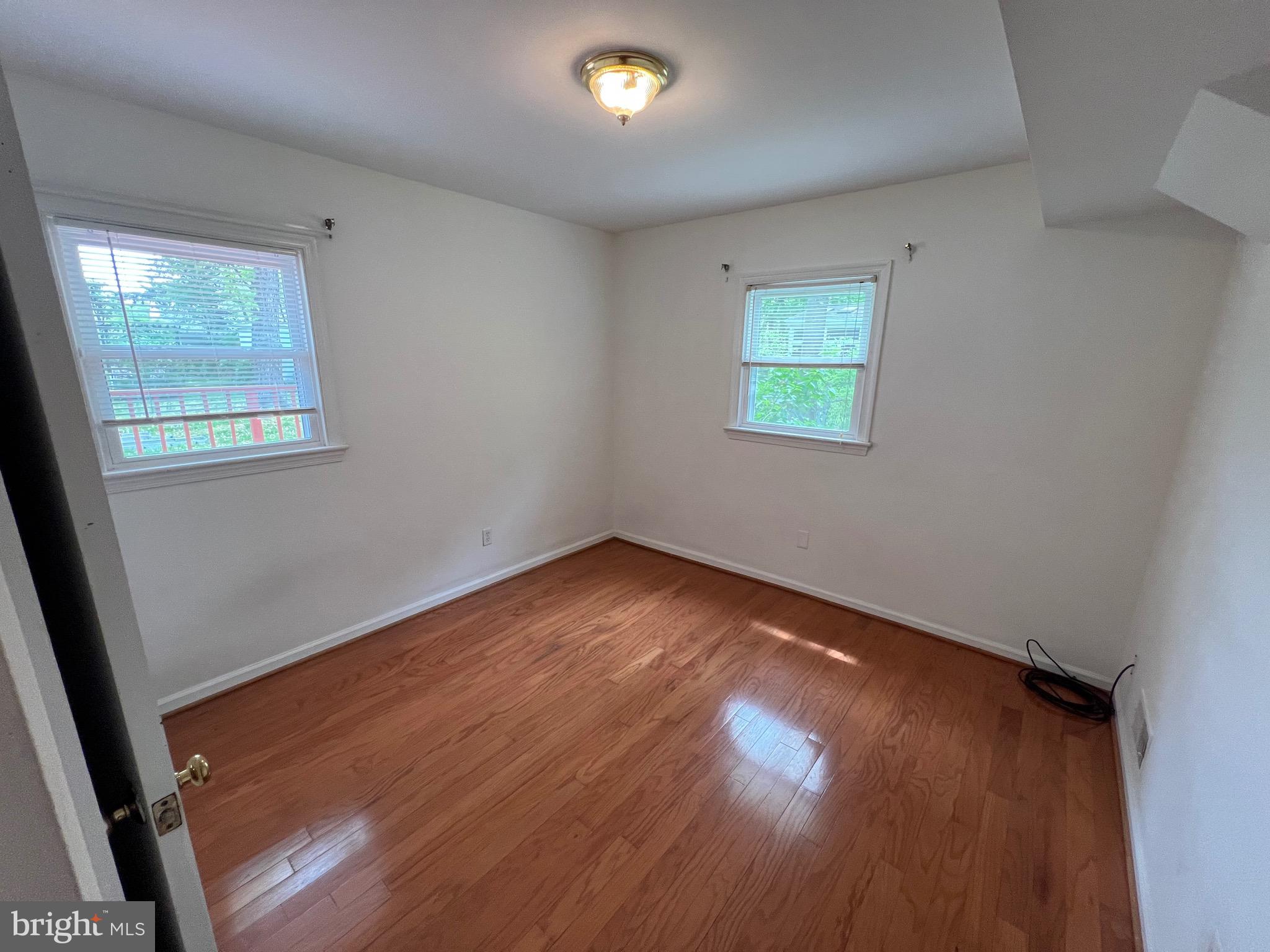 6825 Ridgeway Drive Springfield, VA 22150 - Photo 25 of 33 an empty room with wooden floor and windows