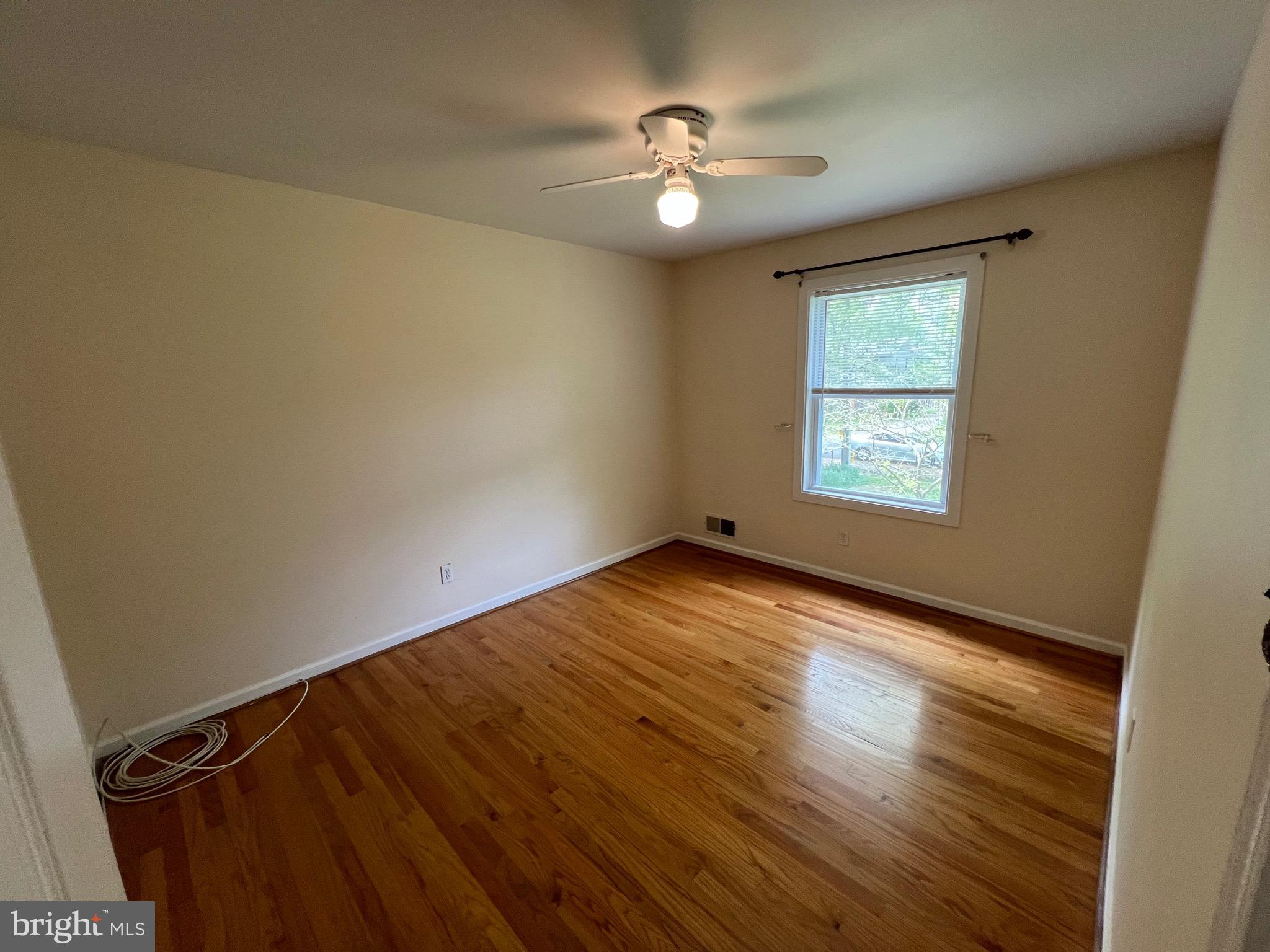 6825 Ridgeway Drive Springfield, VA 22150 - Photo 28 of 33 a view of an empty room with a window and wooden floor