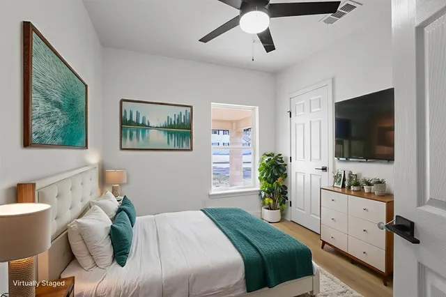 a bedroom with a bed and a flat screen tv