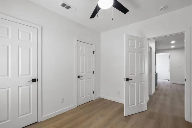 a view of a hallway with wooden floor