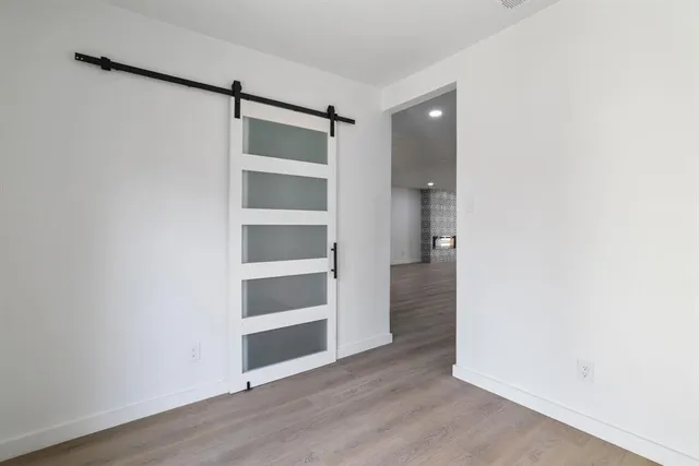 a view of an empty walk in closet with wooden floor