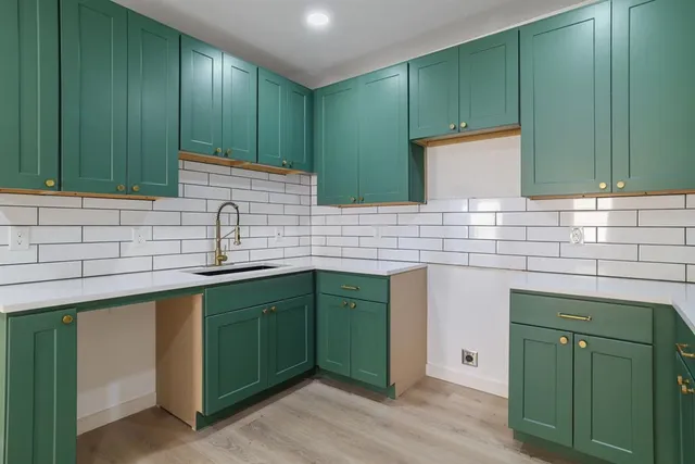 a kitchen with stainless steel appliances granite countertop a sink and a microwave