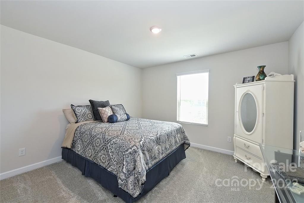 3838 Isenhour Road Kannapolis, NC 28081 - Photo 15 of 17 a bedroom with a bed a washer and dryer