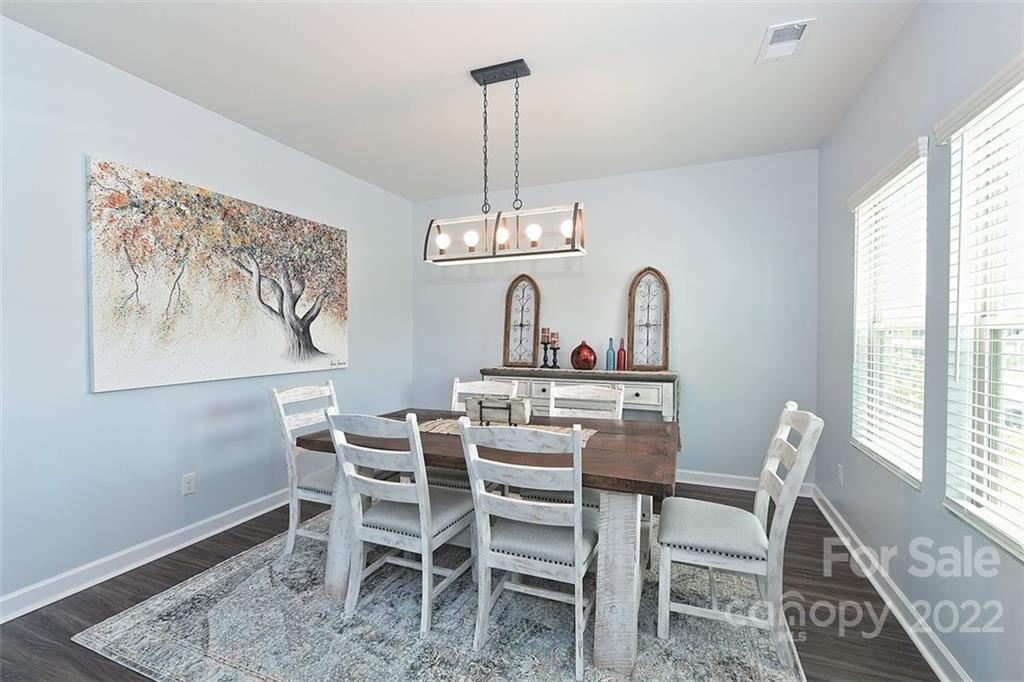 3838 Isenhour Road Kannapolis, NC 28081 - Photo 2 of 17 a dining room with furniture a rug and wooden floor