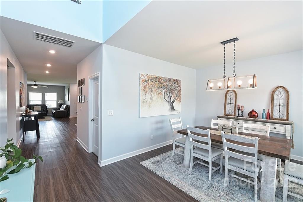 3838 Isenhour Road Kannapolis, NC 28081 - Photo 3 of 17 a view of a dining room with furniture wooden floor and a chandelier