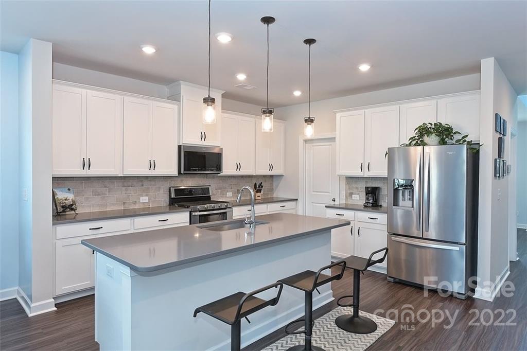 3838 Isenhour Road Kannapolis, NC 28081 - Photo 4 of 17 a kitchen with refrigerator cabinets and wooden floor