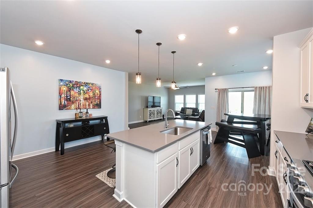 3838 Isenhour Road Kannapolis, NC 28081 - Photo 6 of 17 a kitchen with a stove and a wooden floor